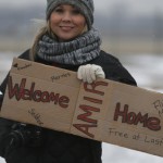 Flint resident Stephanie Walker holds a ‘Welcome Home’ sign outside the airport where former U.S. Marine Amir Hekmati, recently released from an Iranian prison, arrived in Flint, Michigan